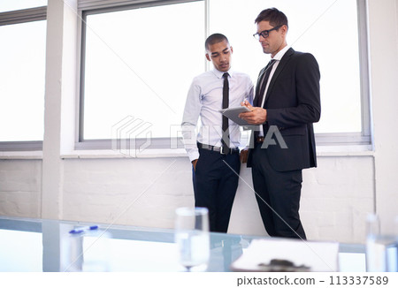 Business men, tablet and partnership on plan in discussion, office and collaboration on idea. Colleagues, teamwork and internet for online research, website and communication in workplace for support 113337589