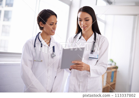Doctor, tablet and women with research, hospital and tech in a clinic with healthcare and wellness. Lab, working and online article with professional medical staff and physician worker at a job 113337802
