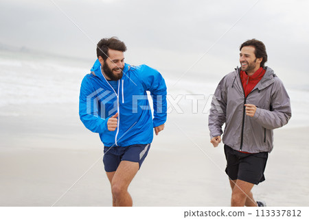 Laugh, men and running on beach, sand and fitness for wellness and gym wear on ocean coast workout. Male athletes, jog and training for seaside, health and outdoor for sport and exercise together 113337812