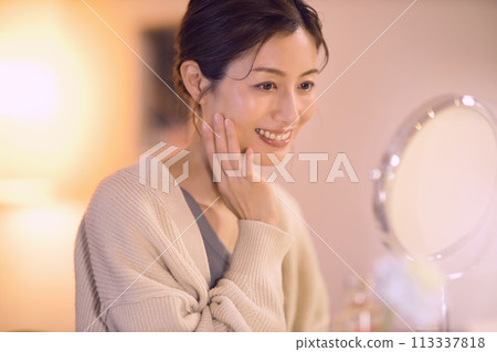 Middle-aged woman doing night skin care 113337818