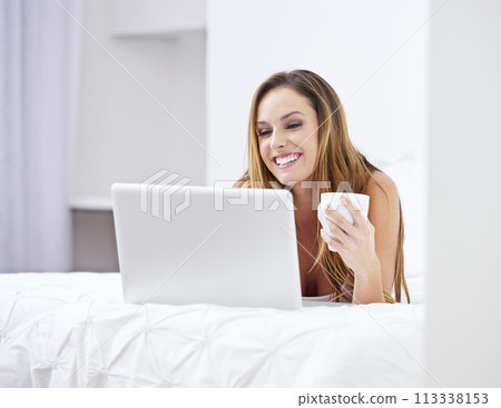 Woman, bedroom and coffee on laptop for relax, search website and registration or streaming at home. Young person online on bed with computer for morning news, social media update or reading blog 113338153