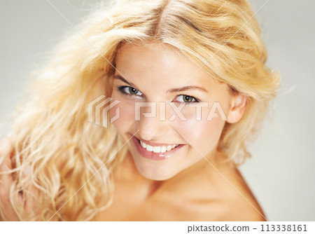 Portrait, smile and natural beauty of blonde woman in studio isolated on a white background. Face, happy model and skincare of girl in spa facial treatment for wellness, cosmetics and dermatology 113338161