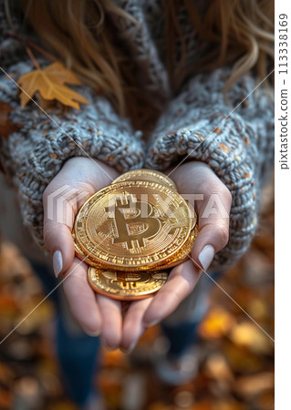 Golden Bitcoin in hands 113338169