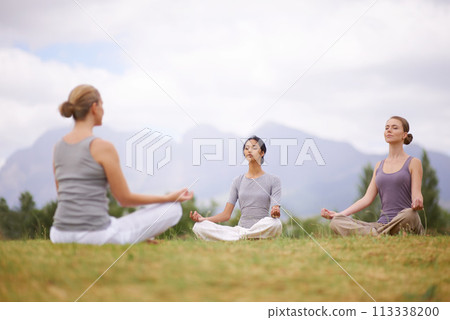 Lotus, instructor and meditation outdoor for yoga, healthy body and mindfulness exercise to relax. Peace, group and calm women in padmasana in nature for balance, spirituality or breathing together 113338200