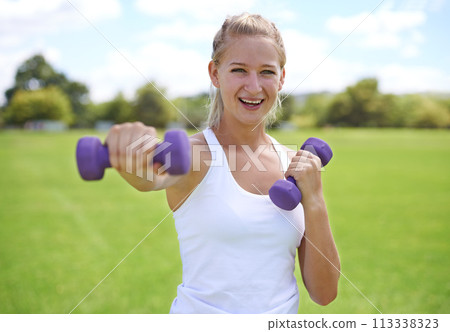 Woman, portrait and dumbbells, weightlifting for exercise and muscle, athlete outdoor for sport and bodybuilding. Healthy, fitness equipment and strong in park with bodybuilder and workout with smile Woman, portrait and dumbbells, weightlifting for exercise and muscle, athlete outdoor for sport and bodybuilding. Healthy, fitness equipment and strong in park with bodybuilder and workout with smile 113338323