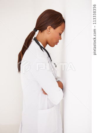 Tired black woman, doctor and stress in fatigue, burnout or healthcare from mistake at hospital. Face of exhausted African female person, surgeon or medical nurse asleep or leaning on wall at clinic 113338356