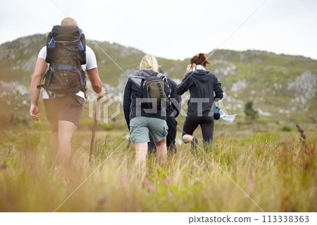 Nature, backpack and group of friends on hiking adventure in mountain with freedom from back. Travel, trekking and people walking in countryside, men and women on natural outdoor journey together. Nature, backpack and group of friends on hiking adventure in mountain with freedom from back. Travel, trekking and people walking in countryside, men and women on natural outdoor journey together. 113338363