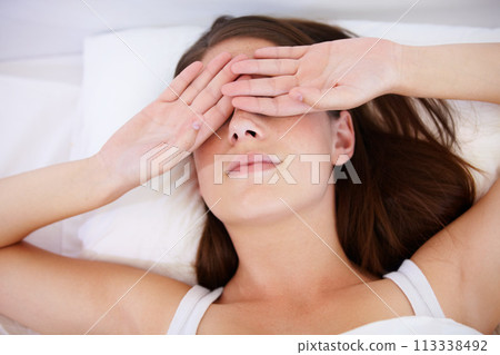 Fatigue, wake up or tired woman in bed with hands on eyes frustrated with insomnia, crisis or disaster. Bedroom, burnout or lady person in house with sleeping issue, struggle or low energy from above 113338492