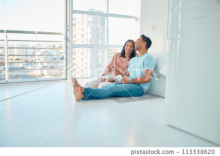 Full length of young happy mixed race couple sitting together on floor of their new apartment and drinking coffee. Smiling hispanic couple bonding and laughing while enjoying the morning as homeowner Full length of young happy mixed race couple sitting together on floor of their new apartment and drinking coffee. Smiling hispanic couple bonding and laughing while enjoying the morning as homeowner 113338620
