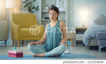 Woman, yoga and stretching for fitness, wellness in healthy spiritual zen exercise for mental wellbeing at home. Female in calm, relax and peaceful exercising workout for mind, body and spirit on mat 113338698