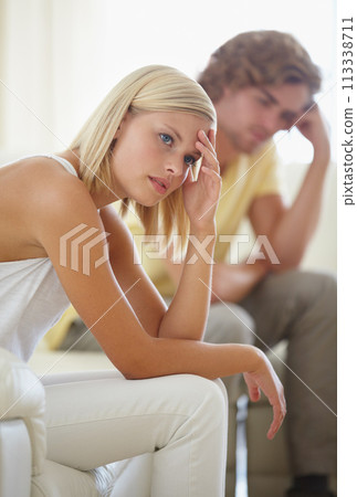 Divorce, fight and couple on sofa with stress, anxiety or cheating depression in their home. Marriage, crisis and frustrated woman overthinking in living room with commitment, doubt or liar conflict 113338711