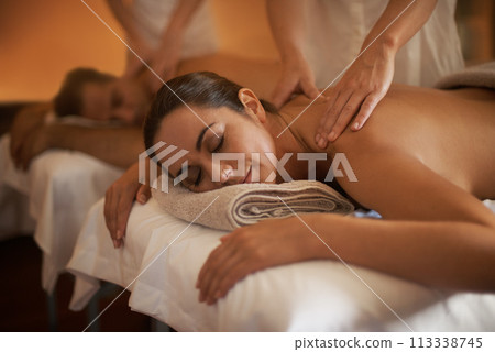 Hands, back massage or calm couple in spa to relax on bed for luxury pamper treatment together in hotel. Beauty, sleep or zen woman with man at resort or salon for natural healing benefits or body 113338745