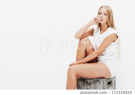 Woman, portrait and sitting on crate, fashion or white background for style, young person or confident. Clean, face and female model with mockup space, body glow and studio backdrop with clothes Woman, portrait and sitting on crate, fashion or white background for style, young person or confident. Clean, face and female model with mockup space, body glow and studio backdrop with clothes 113338929