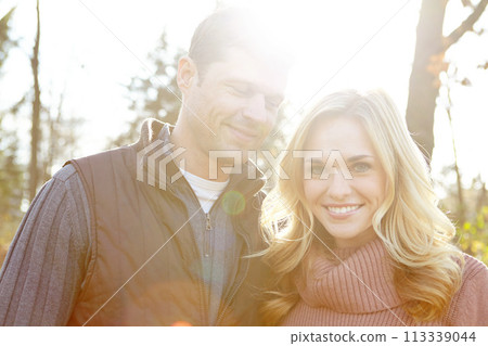 Fall is their favorite season. A happy and loving couple spending time out in the woods together. Fall is their favorite season. A happy and loving couple spending time out in the woods together. 113339044