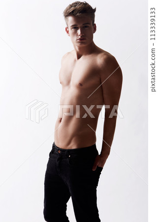 Portrait, natural and masculine with body of man in studio on white background for health or wellness. Aesthetic, beauty and skin with young shirtless model in jeans for hygiene and satisfaction 113339133