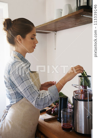 Vegetables, fruit and woman with blender for smoothie in morning at cafe or prepare juice with kale. Breakfast, nutrition and person mixing healthy protein shake in kitchen with machine for diet Vegetables, fruit and woman with blender for smoothie in morning at cafe or prepare juice with kale. Breakfast, nutrition and person mixing healthy protein shake in kitchen with machine for diet 113339146