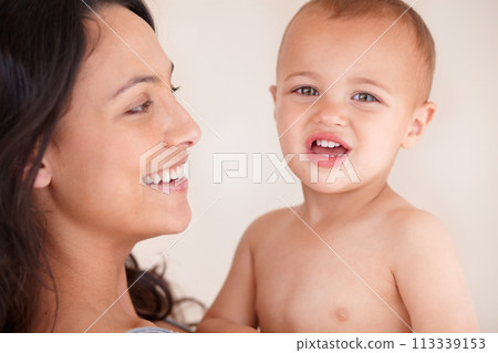 Family, relax and mother with baby on a white background for bonding, relationship and happy together. Love, youth and portrait of mom carrying kid for growth, playing and child development in studio 113339153