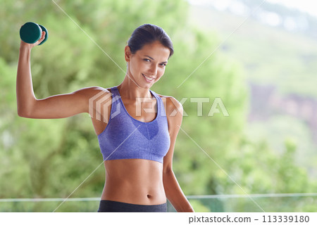 Happy woman, portrait and weightlifting with dumbbells for workout, exercise or muscle gain on balcony. Young female person with smile and small barbell for fitness or outdoor training on terrace 113339180