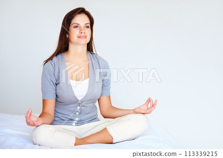 Yoga, meditation and woman with peace in bedroom or spiritual zen in morning from breathing. Calm, lotus and mindfulness exercise in home with person to relax with benefits of self care in mockup 113339215