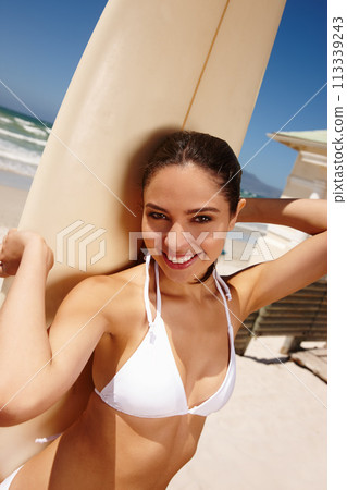 Woman, beach and surfboard for surfing or portrait with happiness, adventure and fitness with bikini. Tourist, person and surfer by ocean in morning for holiday, vacation and freedom in California 113339243