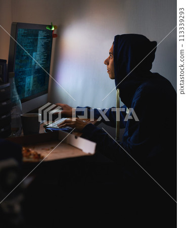 Night, hacker or man with computer, tech or typing with server or programmer with nerd or geek. Person, home or guy with pc or online reading with dark room or cyber security with network or internet 113339293
