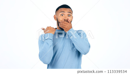 Shock, pointing and portrait of man in a studio with wow, omg or wtf facial expression for news. Surprise, emoji and face of young male person from Colombia isolated by white background with mockup. 113339534