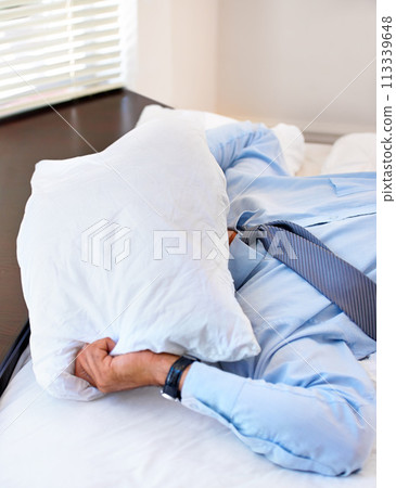 Stress, pillow and tired with business man in bedroom for frustrated, fatigue and fear. Mistake, mental health and burnout with exhausted person in bed at home for overworked, sad and crisis 113339648