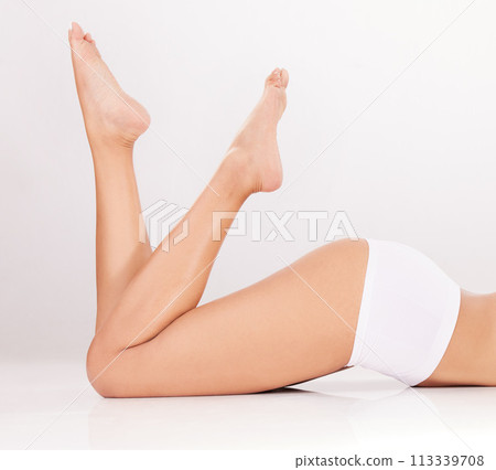 I love every inch of my body. a woman showing off her legs against a grey background. 113339708