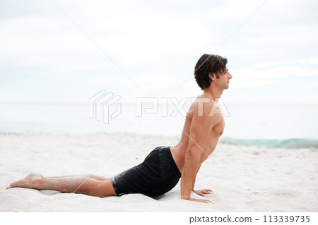 Man, yoga and stretch on beach sand for relax summer, zen or sunshine exercise for health. Male person, cobra pose and muscle for holistic sea practice, spiritual balance or calm ocean mockup Man, yoga and stretch on beach sand for relax summer, zen or sunshine exercise for health. Male person, cobra pose and muscle for holistic sea practice, spiritual balance or calm ocean mockup 113339735