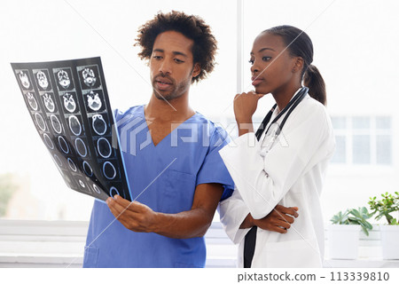Doctor, nurse and study xray for health, collaboration for surgery and treatment plan with anatomy. Black people review abdominal CAT scan, MRI or radiology, medicine and surgeon with team at clinic Doctor, nurse and study xray for health, collaboration for surgery and treatment plan with anatomy. Black people review abdominal CAT scan, MRI or radiology, medicine and surgeon with team at clinic 113339810