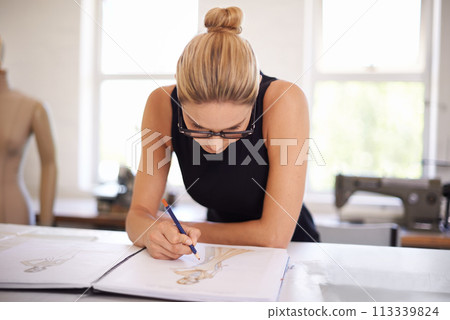Fashion, designer and woman drawing as planning for clothes, ideas and brainstorming in workshop. Creative, tailor or person sketch in notebook with inspiration for unique style in boutique studio 113339824