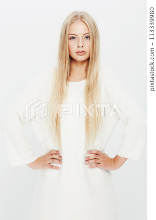 Blonde woman, portrait and fashion in confidence for natural beauty in haircare, cosmetics or makeup on a white studio background. Face of young female person or attractive model in stylish outfit 113339980