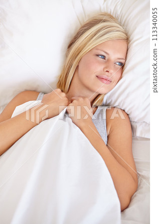 Wake up, peace and calm woman in a bed thinking, resting and comfortable at home from above. Smile, face and female person lying in a bedroom with vacation, holiday or nap on her day off in a house 113340055