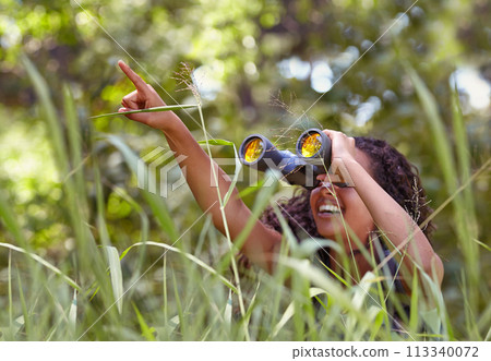 Nature, binoculars and girl in grass for exploring in park on vacation, adventure or holiday. Travel, forest and young child or kid with equipment in lawn in outdoor field or woods on weekend trip. Nature, binoculars and girl in grass for exploring in park on vacation, adventure or holiday. Travel, forest and young child or kid with equipment in lawn in outdoor field or woods on weekend trip. 113340072