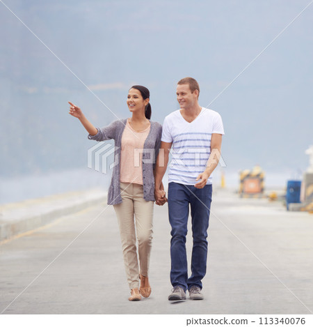 Couple, ocean and happy in boardwalk on vacation for honeymoon, love and relax in New Zealand. Pointing, relationship and beach for travel on holiday with trip for support, bonding and holding hands Couple, ocean and happy in boardwalk on vacation for honeymoon, love and relax in New Zealand. Pointing, relationship and beach for travel on holiday with trip for support, bonding and holding hands 113340076