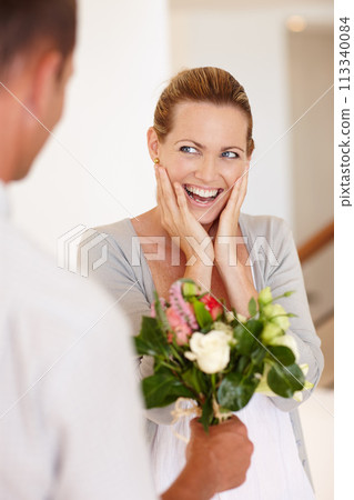 Wow, happy and woman with flowers for wedding, marriage and love with man for bonding in background. Female person, girl and wife with husband for bouquet, union and partnership of couple together 113340084