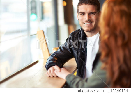 Man, couple and date in coffee shop, hand holding for love and romantic affection. Boyfriend, support together for bonding relationship, female person at table for trust comfort and compassion 113340154