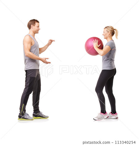 Couple in studio with fitness, gym ball and coaching for exercise, body wellness and advice. Sports workout, man and woman with sphere for balance, training and personal trainer on white background. Couple in studio with fitness, gym ball and coaching for exercise, body wellness and advice. Sports workout, man and woman with sphere for balance, training and personal trainer on white background. 113340254
