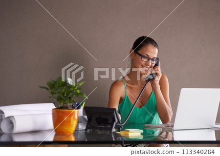 Phone call, remote work and landline with receptionist woman in office for communication or reception. Laptop, smile and happy young woman answering telephone in small business or startup workplace 113340284