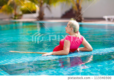 Pregnant woman in swimming pool. Healthy pregnancy Pregnant woman in swimming pool. Healthy pregnancy 113340300