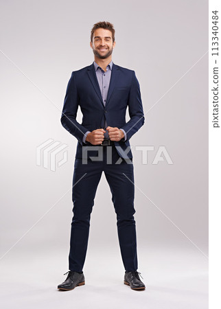 Portrait, studio and happy businessman with confidence, corporate fashion and pride. Salesman, consultant or entrepreneur man in business suit with stylish gentleman clothes on white background 113340484