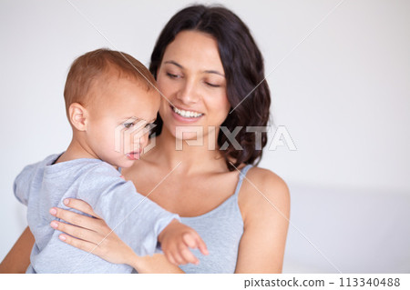 Mom holding toddler in home with smile, bonding and child care with support in morning. Happy woman, baby boy and spending time together in bedroom with development, trust and safety in mothers love. 113340488
