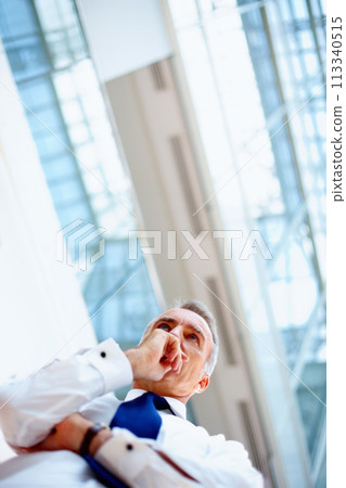 Business, thinking and man with ideas, brainstorming or planning with a project, wonder or opportunity. Low angle, agent or entrepreneur with decision, choice or solution with professional or startup 113340515