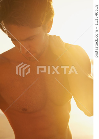 Man, shirtless and travel to beach at sunset, confidence and tourist at sea on summer holiday. Male person, topless and outdoor adventure for fun, calm ocean and peaceful environment in nature Man, shirtless and travel to beach at sunset, confidence and tourist at sea on summer holiday. Male person, topless and outdoor adventure for fun, calm ocean and peaceful environment in nature 113340518