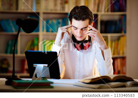 Teenage student at laptop. Teenager with phone. 113340583