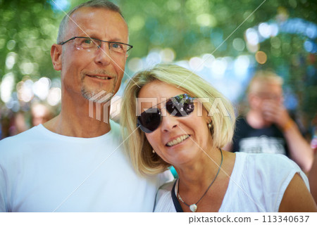 Senior couple, portrait and happy at music festival in nature, excited and bonding with love in forest. Mature man, woman and smile on face at summer carnival and care on retirement holiday in europe 113340637