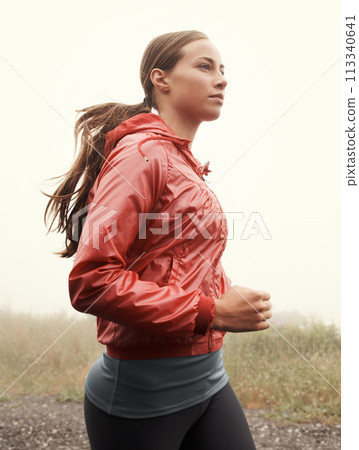 Nature, sports and woman athlete running on mountain road for race, marathon or competition training. Fitness, exercise and female person with cardio workout in misty outdoor woods or forest. 113340641
