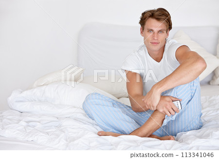 Man, portrait and bed relax in morning or pajama in apartment for weekend, rest or casual. Male person, face and comfortable pillow or remote control for vacation care for home peace, cozy or happy Man, portrait and bed relax in morning or pajama in apartment for weekend, rest or casual. Male person, face and comfortable pillow or remote control for vacation care for home peace, cozy or happy 113341046