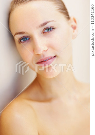 Portrait, beauty and happy with the face of a woman on a wall background for natural wellness. Relax, skincare and cosmetic treatment with a person at the spa or salon for dermatology or self care 113341160