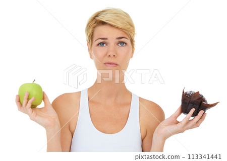 Woman, fitness and health for food doubt, nutrition and decision by studio for lifestyle. Female person, athlete and portrait for diet, workout and white background with apple and cake choice Woman, fitness and health for food doubt, nutrition and decision by studio for lifestyle. Female person, athlete and portrait for diet, workout and white background with apple and cake choice 113341441